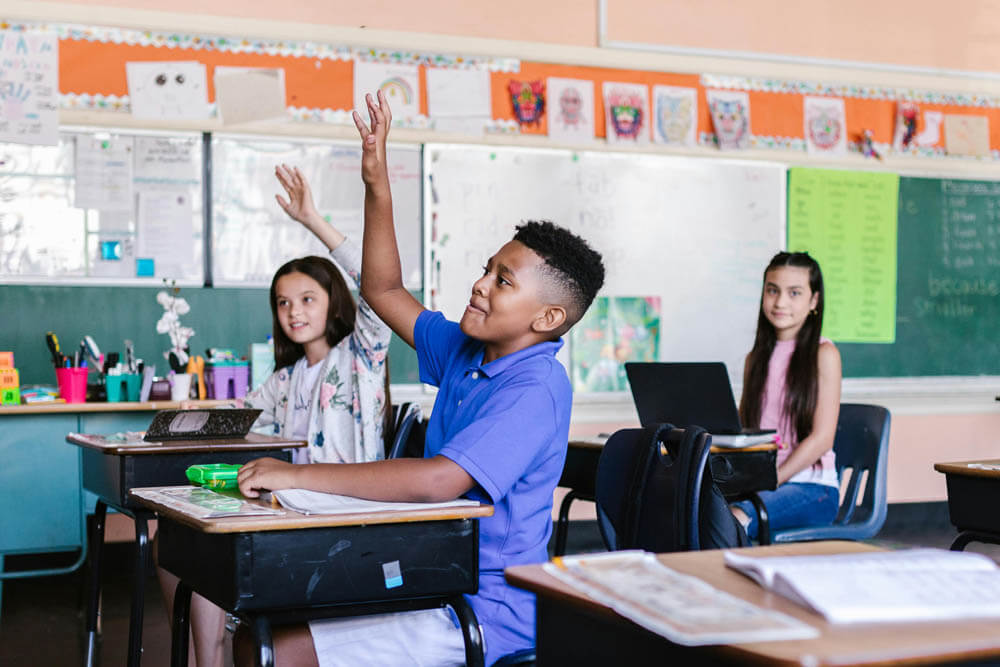 students raising hands