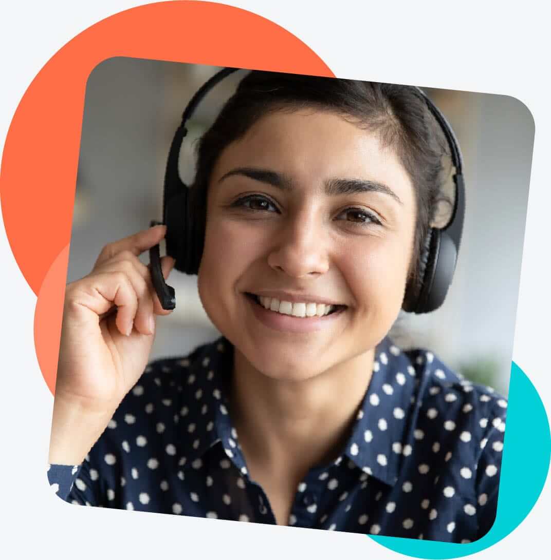 dyslexia therapist wearing a headset and holding the microphone while smiling at the camera