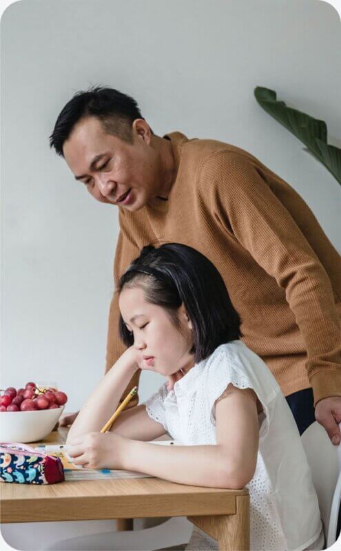 dad and daughter working on homework together